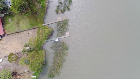 aerial birds eye view of houseboats, jetties and holiday shacks along the beautiful river murray in south australia