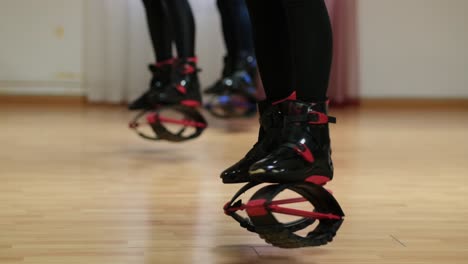 women perform sports exercises in boots кangoo jumps