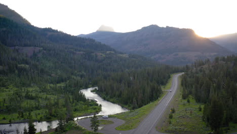 scenic mountain road and river at sunset