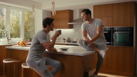 Two men having coffee and a conversation in a modern kitchen