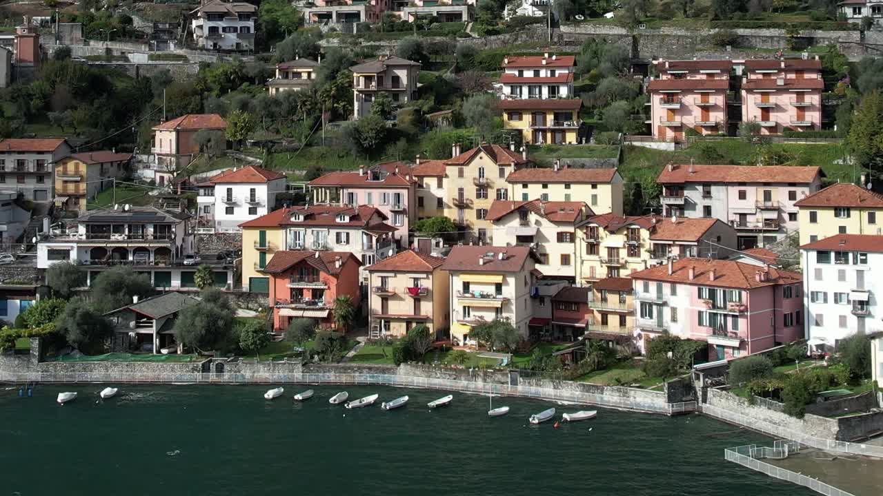 Aerial view of vibrant houses by a tranquil Italian lake