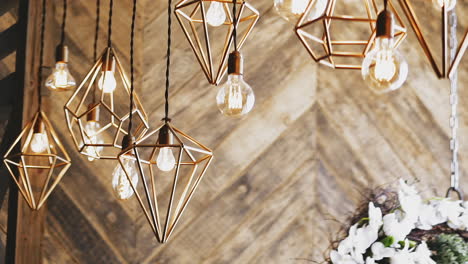 steampunk lusters and light bulbs hang on ceiling in room