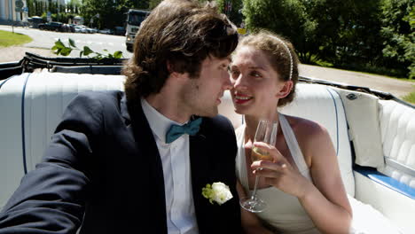 just married couple in a blue convertible car