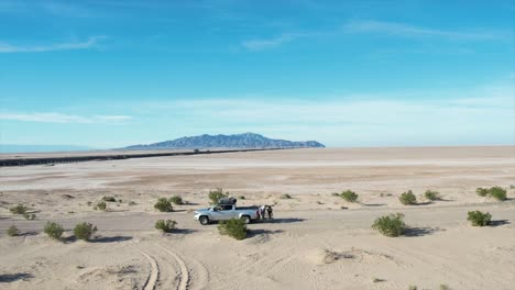 driving along a sandy road on the baja peninsula with a backdrop of the sole hill in the distance