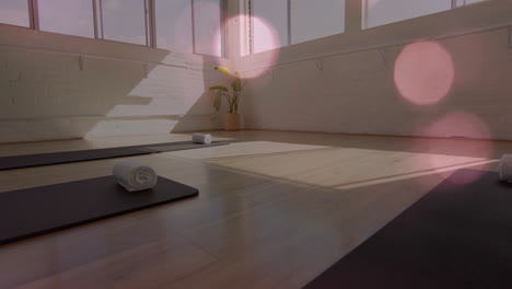 yoga mats and towels in studio with light bokeh animation