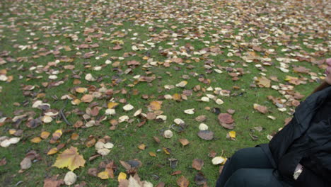 woman on wheelchair wearing a black jacket looking at the camera - wide pan shot
