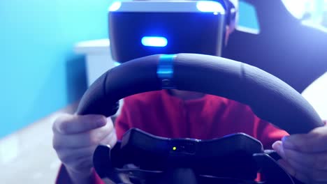 person wearing vr headset and driving simulator