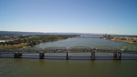 aerial pulling away from the columbia river interstate bridge connecting traffic from vancouver, washington to portland, oregon