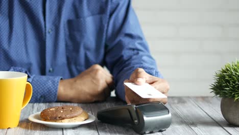 paying with credit card at a cafe