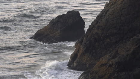 Ocean-Waves-Breaking-in-Steep-Rocky-Cliffs-on-a-Cloudy-Day,-Slow-Motion-120fps