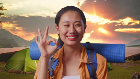 happy woman camping at sunset