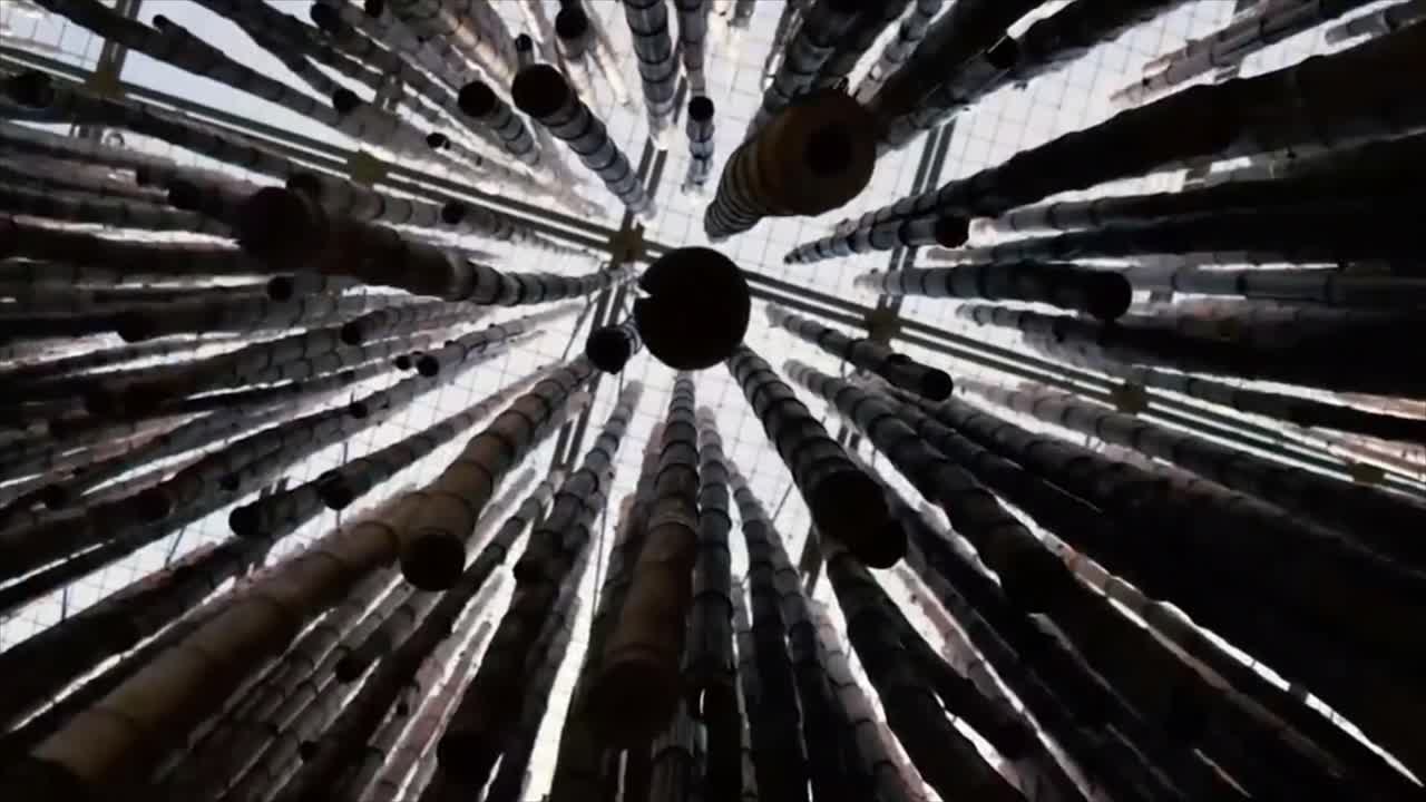 Swaying Bamboo Poles Hanging from a Ceiling in an Abstract Installation