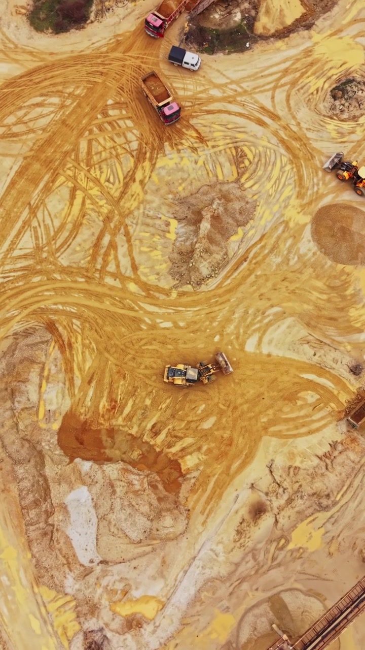 Aerial View of Heavy Machinery Operating in an Open Pit Sand Mine