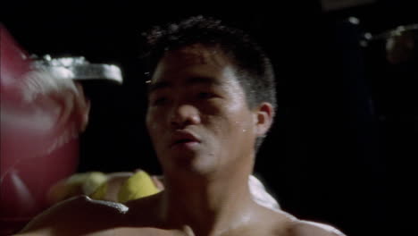 a boxer works out with a punching bag