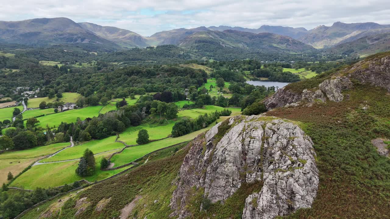 Aerial drone footage capturing sweeping views over Loughrigg Fell in the Lake District on a clear summer’s day