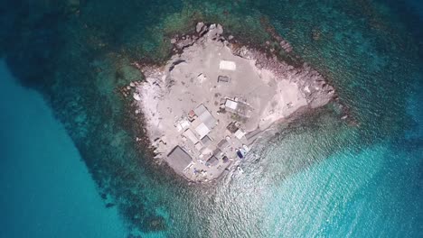 Aerial-cenital-shot-of-a-small-remote-island-of-fishermen,-Coyote-Island,-Sea-of-Cortez