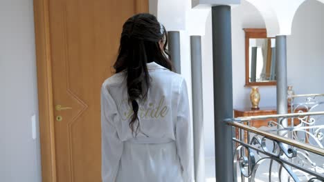 a newlywed on the morning of his wedding, walks through the corridors of her home, she is dressed in a bride's bathrobe