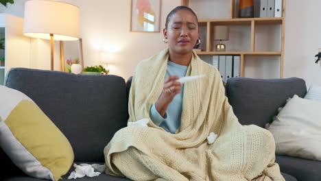 sick woman taking her temperature with an oral