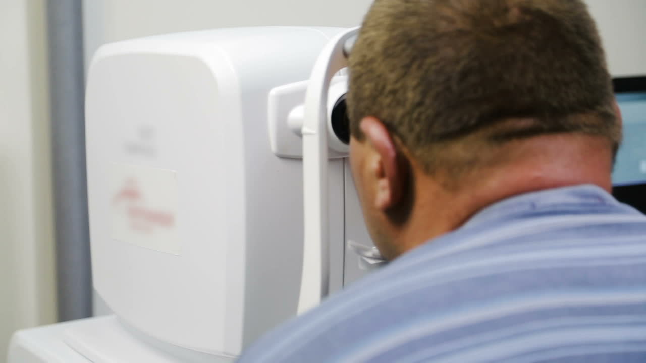 Man taking eye test examination. Ophthalmologist doing eye test on man patient in clinic