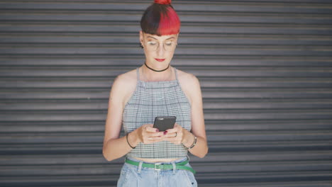 a-woman-using-a-smartphone-against-an-urban