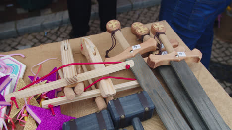 beautiful slow motion in 4k shot of different items for children at a medieval fair in southern spain such as colorful magic wands and shields