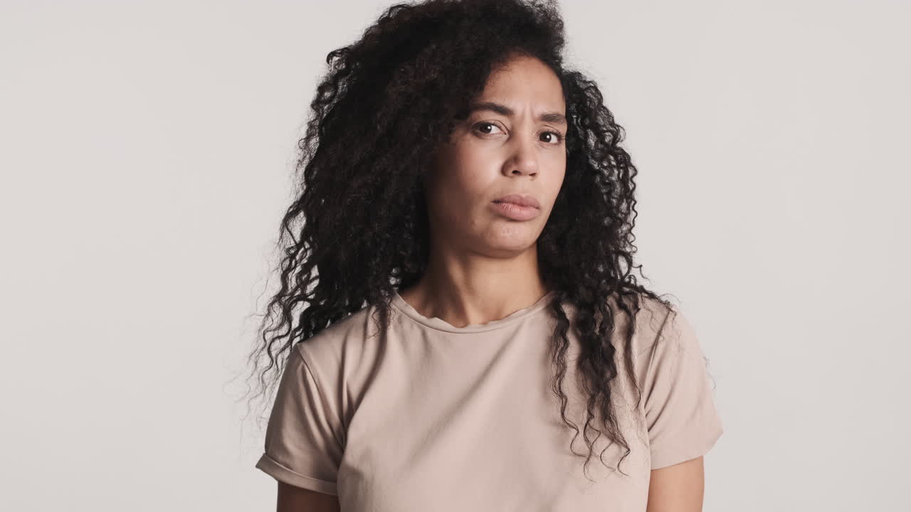 African american dissatisfied woman over white background.