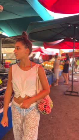 woman shopping at a farmers market