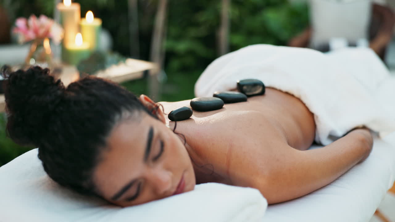 Woman enjoying a hot stone massage at a spa