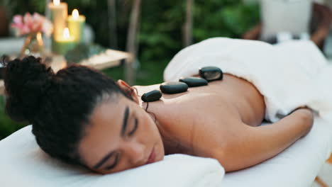 woman enjoying a hot stone massage at a spa