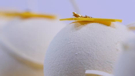 white sphere dessert with gold decorations