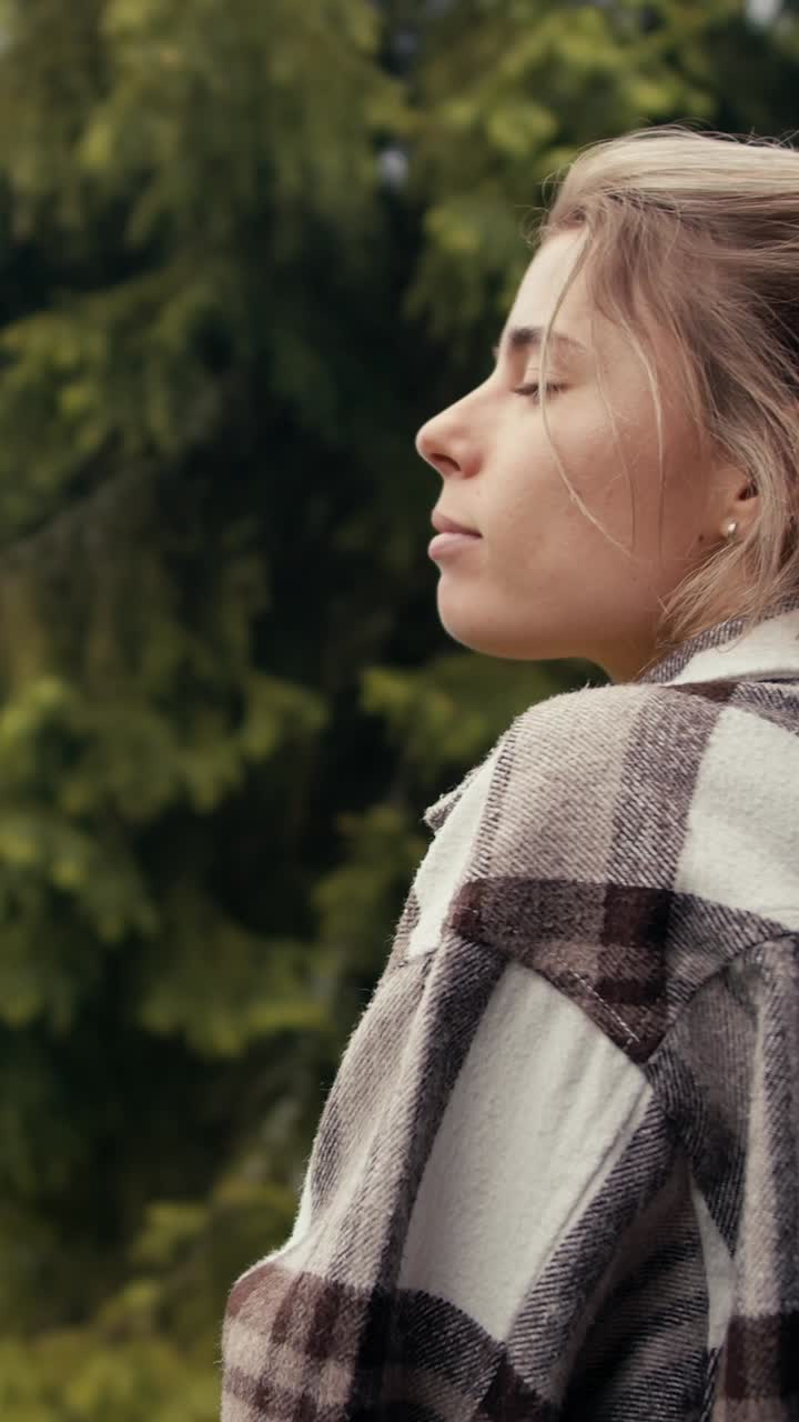 Woman enjoying a coffee outdoors in a forest