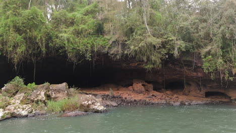 gruta india cave and waterfall in lush forest, misiones, argentina, drone view