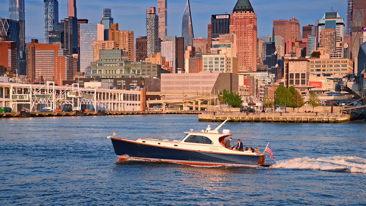 People travel in a speed boat by the river at sunset time. Colorful diverse skyline of New York at backdrop