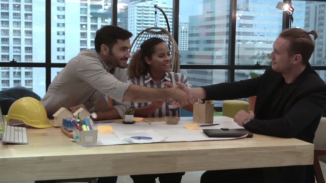 Creative business people group having conversation at office desk in workplace.