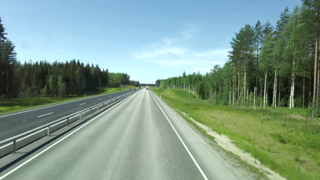 Hyperlapse-video-of-a-two-lane-freeway-on-a-summertime,-filmed-from-upstairs-of-a-bus