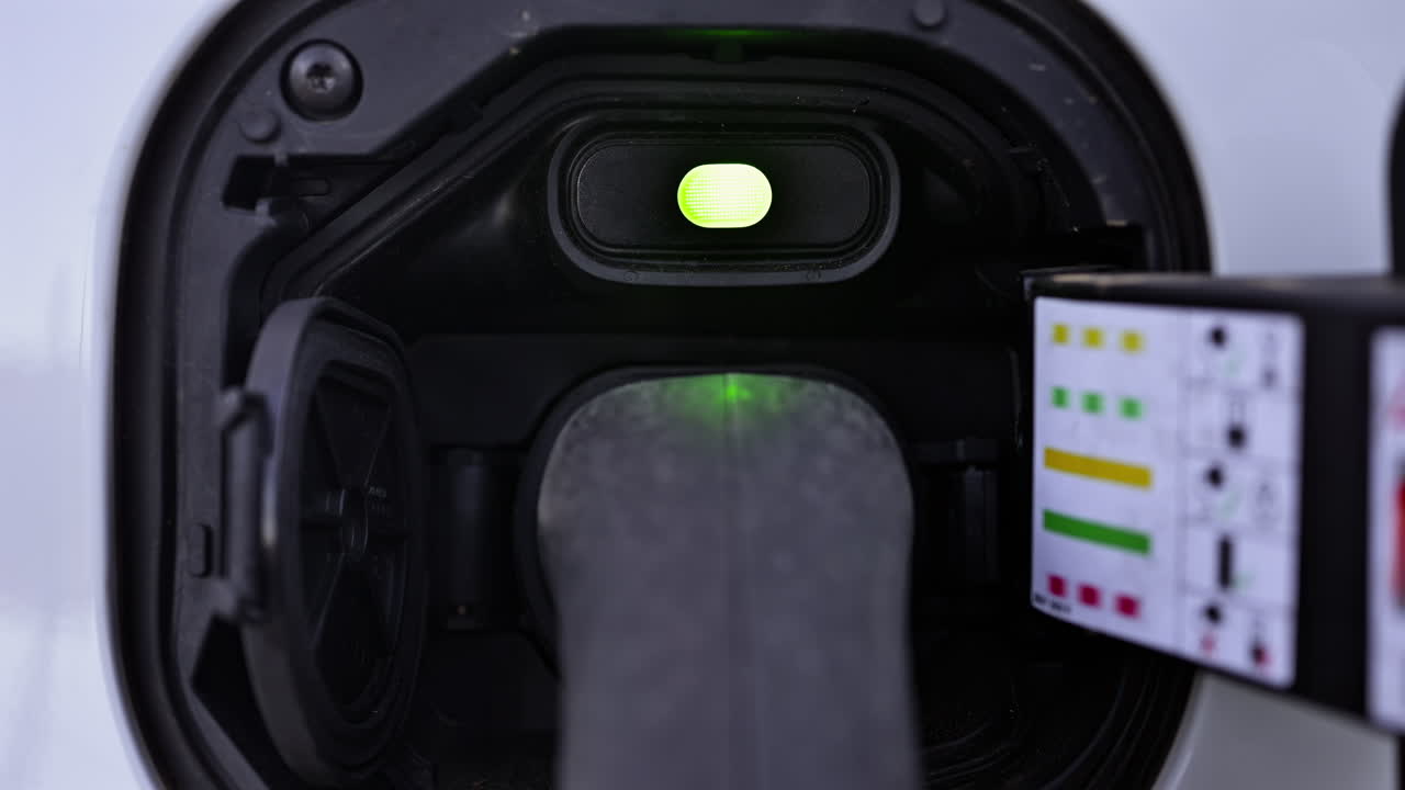 Close up of a white, electric car charging