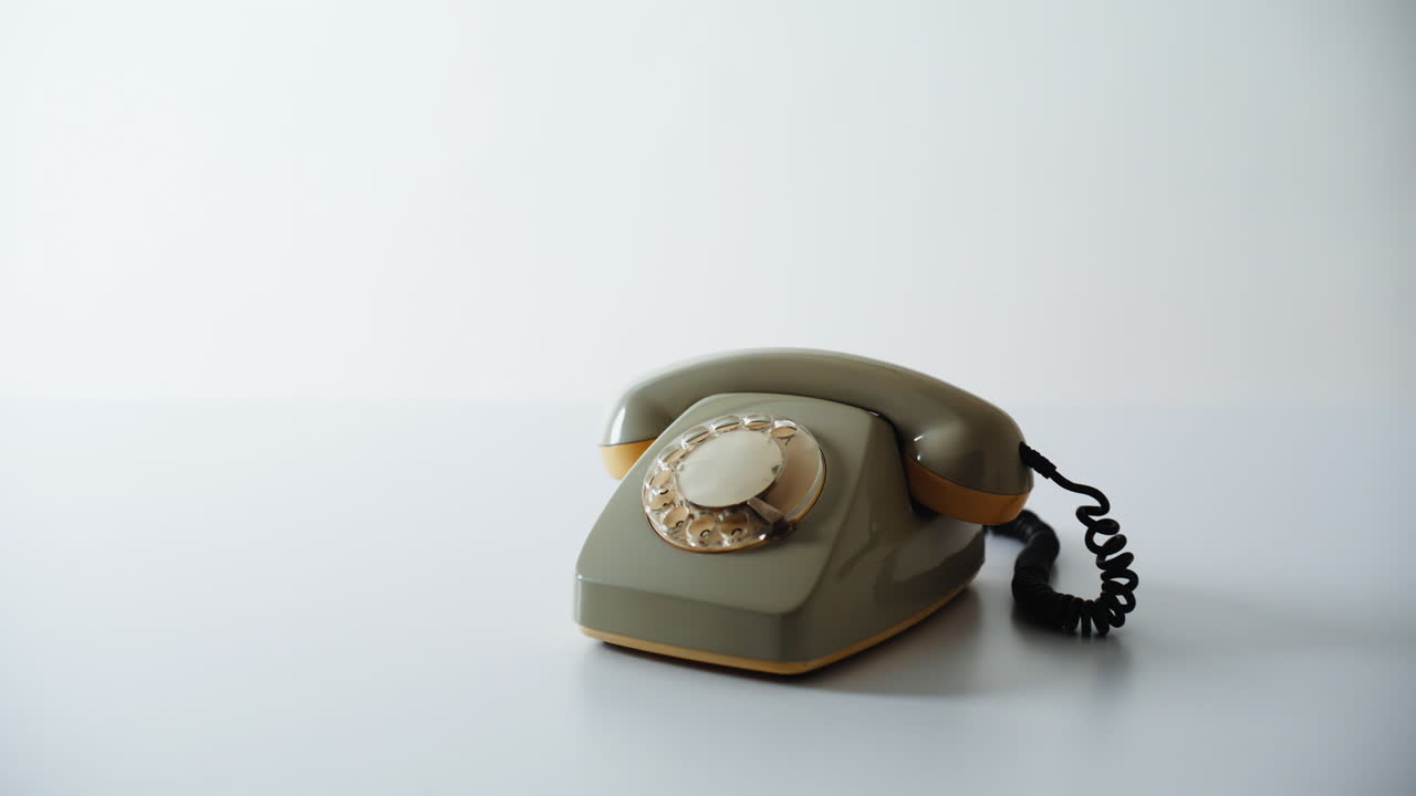 Vintage cellphone standing desk in white background closeup. Rotary device