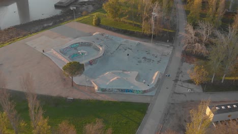 View-from-above-of-skate-park-near-Vasco-da-Gama-Bridge-at-sunrise,-Lisbon