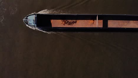 top view of a empty cargo ship traveling on the oude mass river at barendrecht town in netherlands