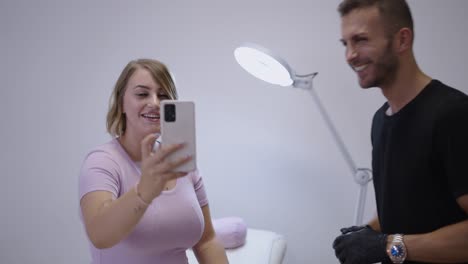 woman recording a video with her smartphone in a beauty or studio setting