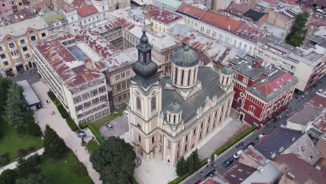 Sarajevo-Cathedral-Serbian-Orthodox-Church-of-the-Nativity-of-the-Theotokos-aerial-view-circling-ornate-bell-tower-and-globe-rooftop