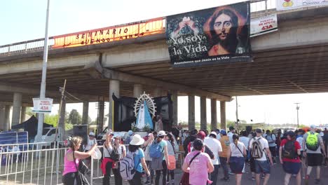 crowds of pilgrims walk at religious virgin mary procession in lujan argentina