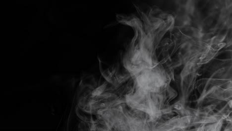 white steam smoke flying up over black background, smog evaporated, slow motion