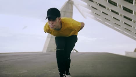 epic portrait and close upt of a young attractive trendy man skateboarding fast under a solar panel on a morning sunny day with an urban city background in slow motion