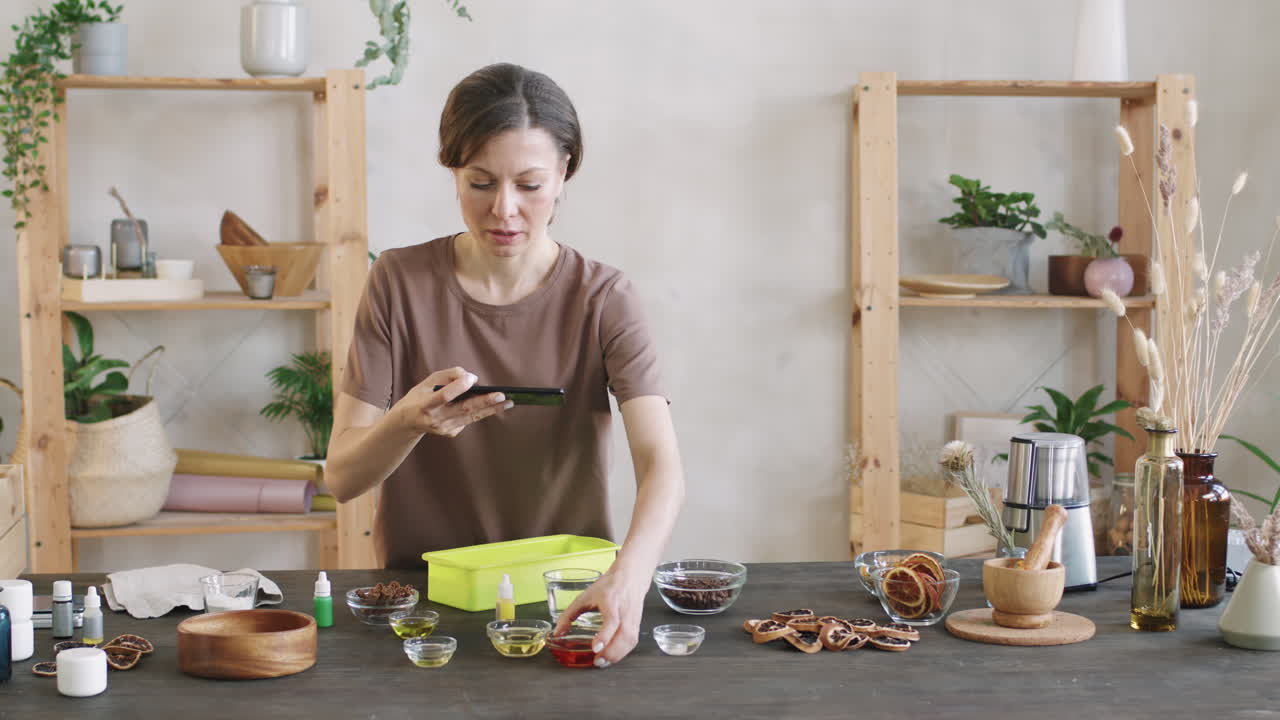 Woman Filming Various Spices In Glass Bowls