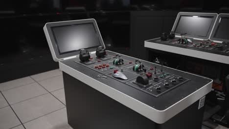 high-tech maritime navigation simulators with control panels and monitors used for training ship operators at a maritime university