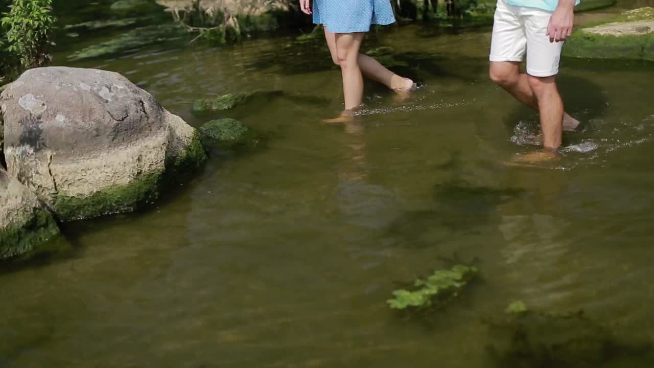 Couple Resting On River Bank. Smiling couple resting on river bank in nature