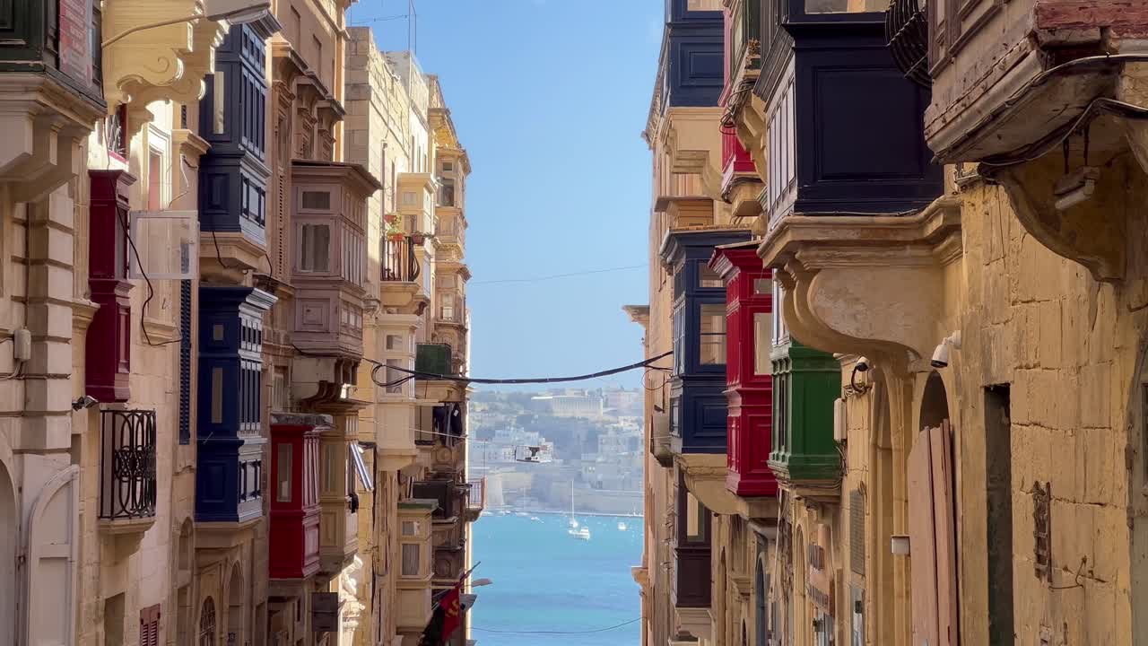4K static Shot showcasing Valetta's Distinctive Baroque and Neo-Classical Architectural Style: Narrow Streets and Vibrant Balconies Depicting the Rich History of Malta's UNESCO World Heritage Site