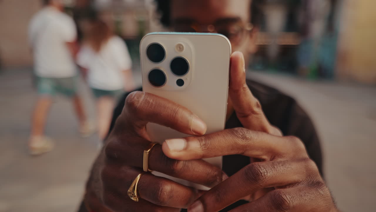 Close-up of Person's Hands Holding a Smartphone to Capture Content Outdoors