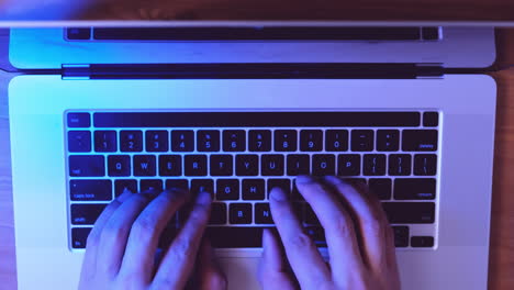 Young-business-man-working-with-laptop-on-desk